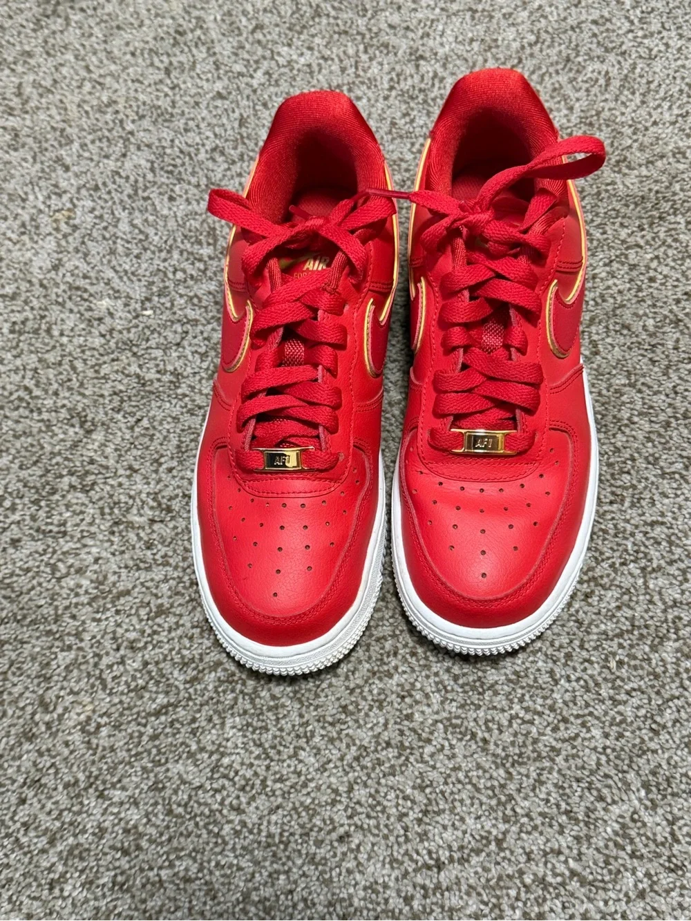 Nike Red Low-Top Sneakers with Gold Swoosh